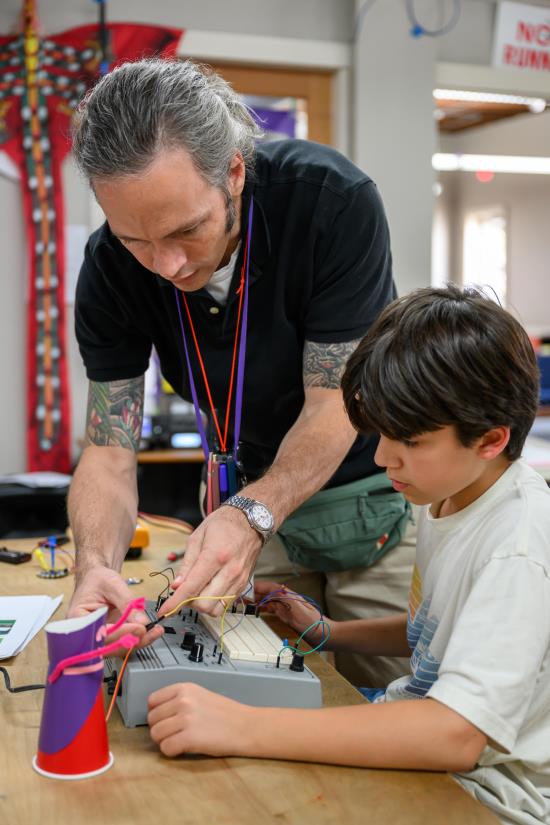 Public Montessori Schools - Maker Space Child and Teacher with Student working on Electronics